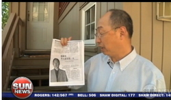 BC Conservative candidate Lawrence Chen holds copy of Frank Huang 2012 article in the Chi-Com's People's Daily paper. 
